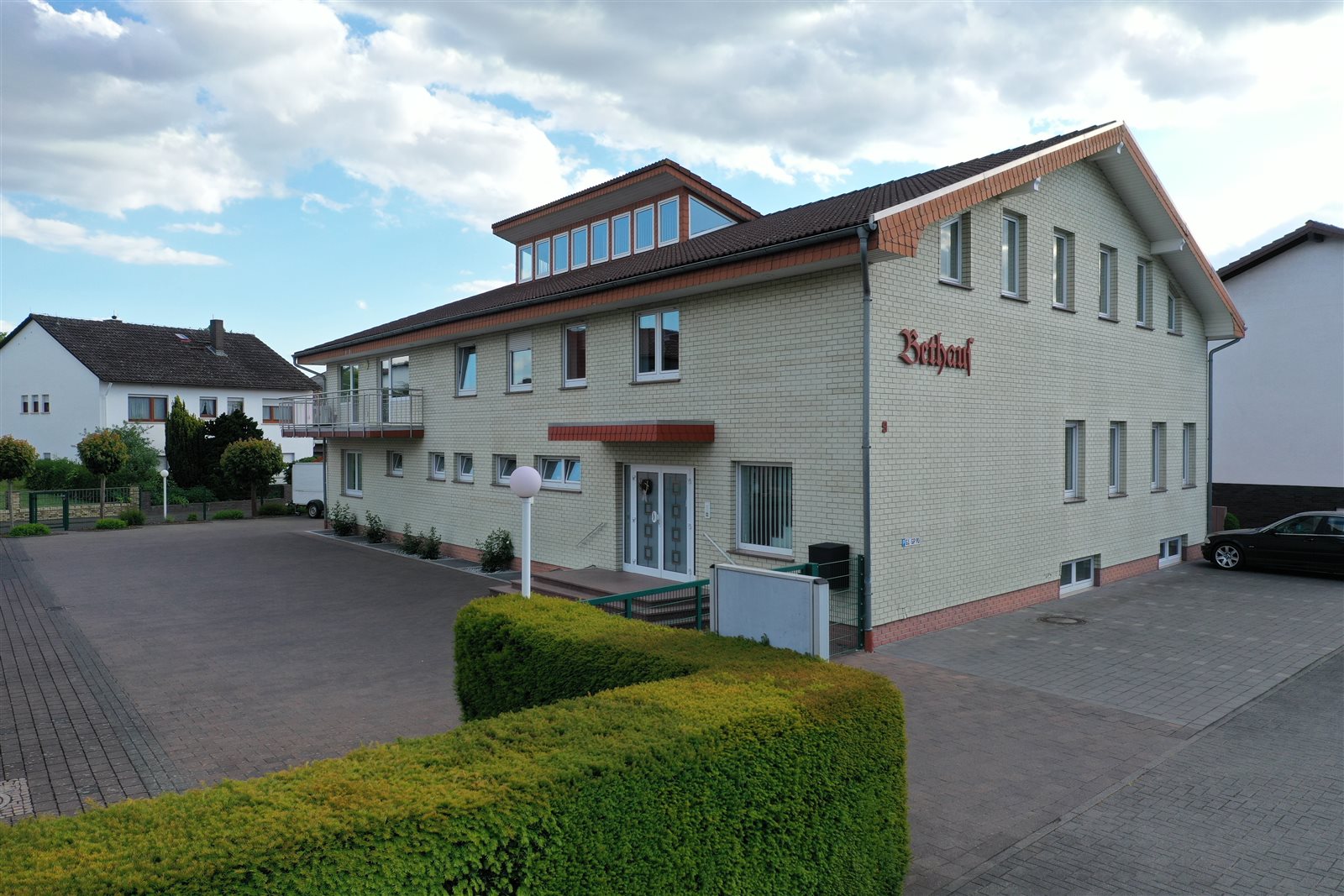 Außenansicht unseres Bethauses mit Eingang und Vorplatz